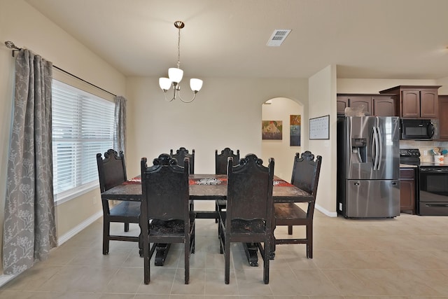 127 Pasture Ln, Decatur, TX 76234 - dining room with a chandelier, light tile patterned flooring, and arched walkways
