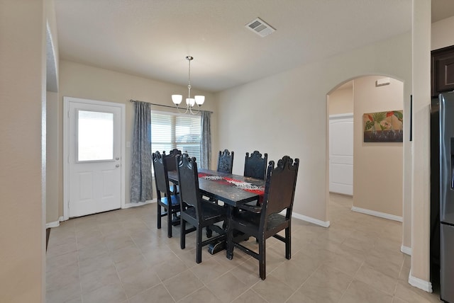 127 Pasture Ln, Decatur, TX 76234 - dining room with arched walkways, a chandelier, and light tile patterned flooring