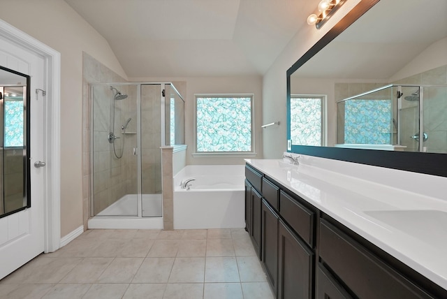 127 Pasture Ln, Decatur, TX 76234 - bathroom with vaulted ceiling, a bath, a stall shower, tile patterned floors, and double vanity
