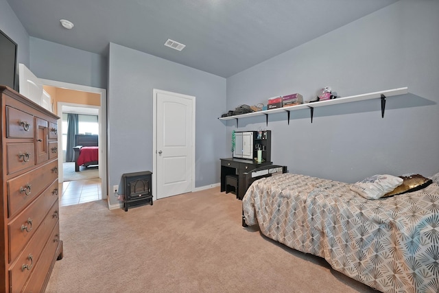 127 Pasture Ln, Decatur, TX 76234 - bedroom featuring a wood stove and light colored carpet