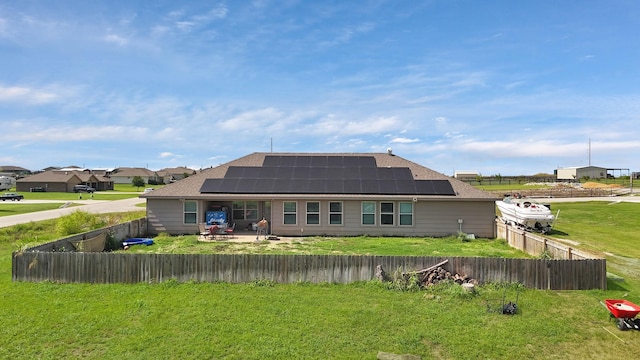 127 Pasture Ln, Decatur, TX 76234 - rear view of property with roof mounted solar panels, a fenced backyard, and roof with shingles