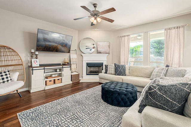 2209 Willard Dr, Mckinney, TX 75072 - living area featuring dark wood-style flooring, ceiling fan, and a fireplace with raised hearth