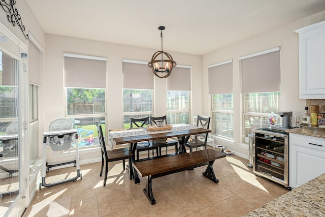 2209 Willard Dr, Mckinney, TX 75072 - dining space with wine cooler, a chandelier, and light tile patterned floors