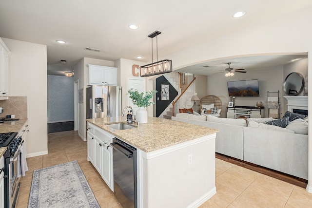 2209 Willard Dr, Mckinney, TX 75072 - kitchen with stainless steel appliances, light tile patterned floors, a ceiling fan, recessed lighting, and an island with sink