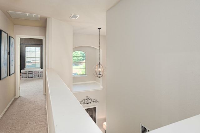 2209 Willard Dr, Mckinney, TX 75072 - hall with light colored carpet, a chandelier, an upstairs landing, and arched walkways