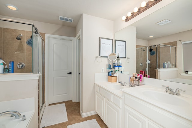 2209 Willard Dr, Mckinney, TX 75072 - bathroom with a shower stall, double vanity, tile patterned floors, and a bath