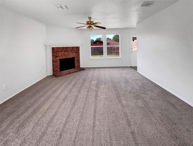 2428 Marimont Ln, Lancaster, TX 75134 - unfurnished living room with ceiling fan, carpet, a textured ceiling, and a fireplace