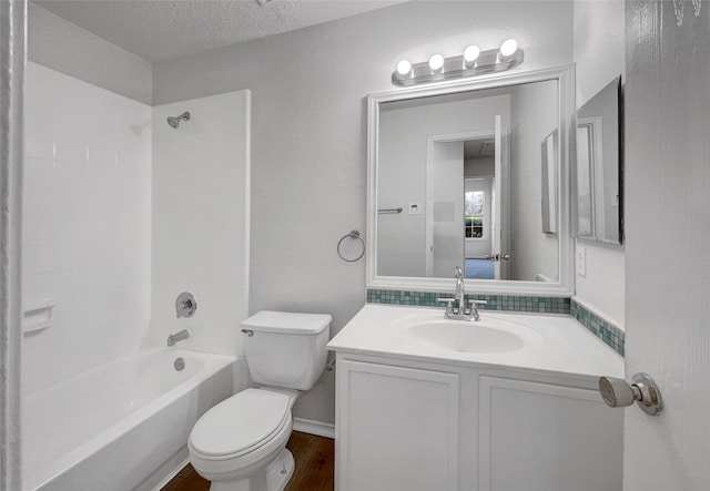 2428 Marimont Ln, Lancaster, TX 75134 - bathroom featuring vanity, shower / bath combination, a textured ceiling, and wood finished floors
