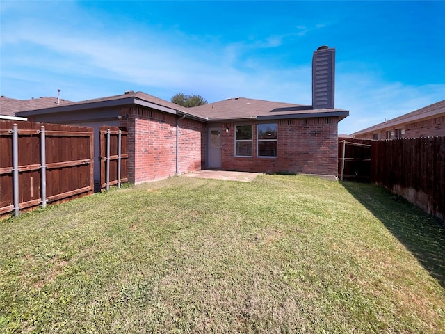 2428 Marimont Ln, Lancaster, TX 75134 - back of property with a chimney, brick siding, a fenced backyard, and a patio