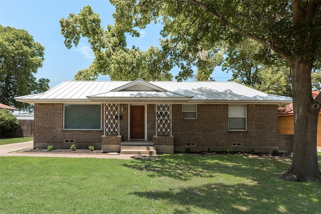 2315 Cardinal Ln, Garland, TX 75042 - view of front of house featuring brick siding, a front lawn, crawl space, a metal roof, and a standing seam roof