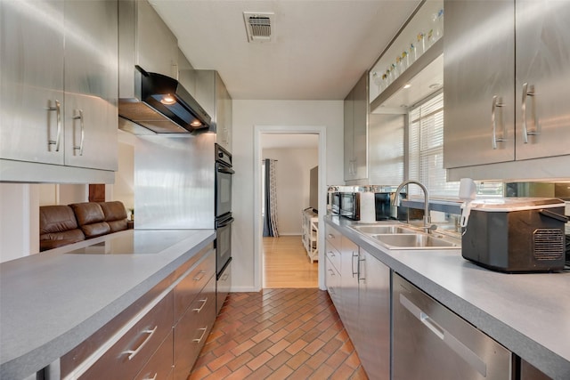 2315 Cardinal Ln, Garland, TX 75042 - kitchen featuring ventilation hood, light countertops, stainless steel dishwasher, electric cooktop, and brick patterned floors