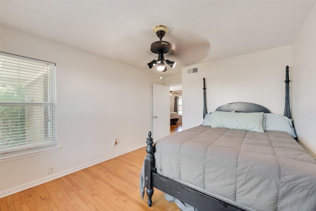 2315 Cardinal Ln, Garland, TX 75042 - bedroom with wood finished floors and ceiling fan