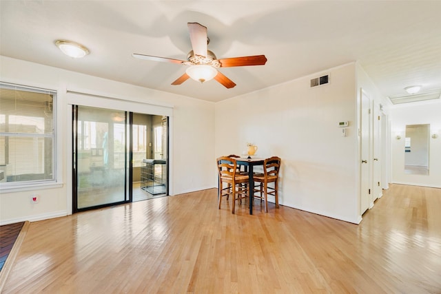 2315 Cardinal Ln, Garland, TX 75042 - dining area featuring light wood finished floors, ceiling fan, and attic access