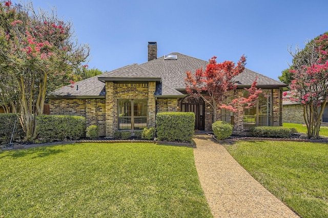 6226 Liberty Hl, Dallas, TX 75248 - view of front of house with a front lawn, brick siding, a chimney, and a shingled roof