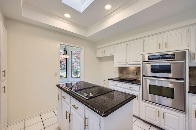 6226 Liberty Hl, Dallas, TX 75248 - kitchen featuring stainless steel double oven, black electric stovetop, a skylight, a tray ceiling, and backsplash