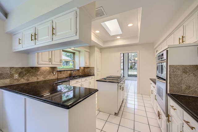 6226 Liberty Hl, Dallas, TX 75248 - kitchen featuring a center island, decorative backsplash, plenty of natural light, stainless steel oven, and recessed lighting