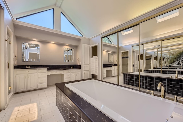 6226 Liberty Hl, Dallas, TX 75248 - full bathroom with tiled tub, tile patterned floors, double vanity, and high vaulted ceiling