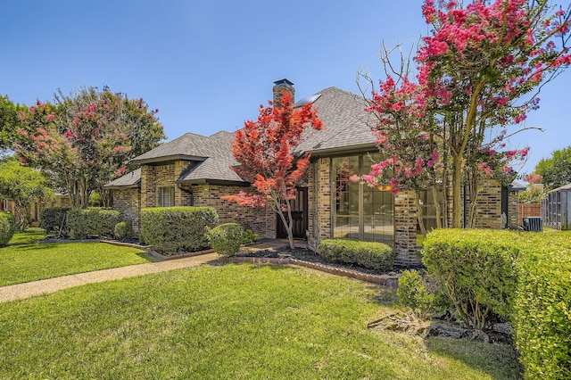 6226 Liberty Hl, Dallas, TX 75248 - view of front of home featuring a front yard, a chimney, and brick siding
