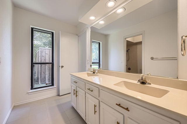 6226 Liberty Hl, Dallas, TX 75248 - bathroom featuring plenty of natural light, double vanity, tile patterned flooring, recessed lighting, and a shower