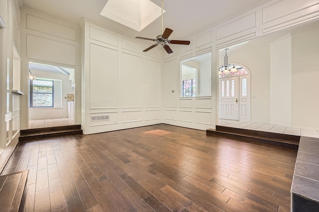 6226 Liberty Hl, Dallas, TX 75248 - unfurnished room featuring a decorative wall, dark wood finished floors, plenty of natural light, and a chandelier