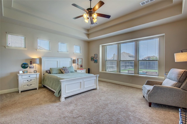 6341 Ashford Trl, Mesquite, TX 75181 - bedroom featuring a raised ceiling, light carpet, and a ceiling fan
