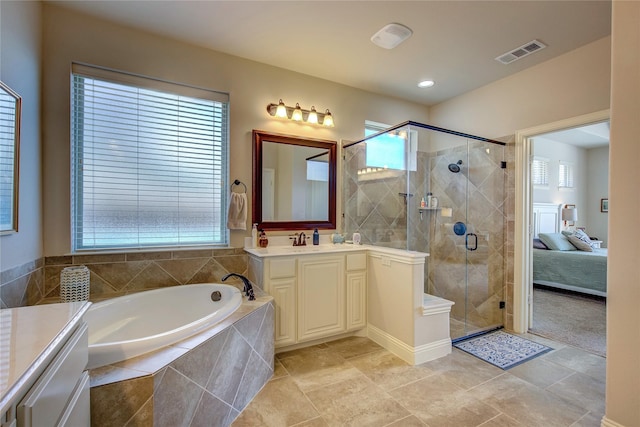 6341 Ashford Trl, Mesquite, TX 75181 - bathroom with vanity, a garden tub, a stall shower, and healthy amount of natural light