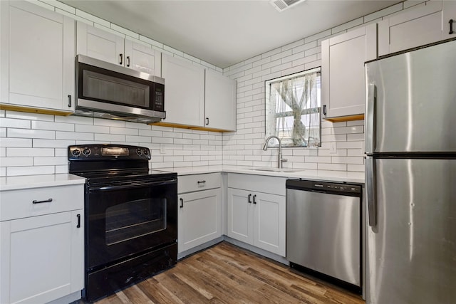 2628 Belhaven Dr, Mesquite, TX 75150 - kitchen with appliances with stainless steel finishes, light countertops, and decorative backsplash