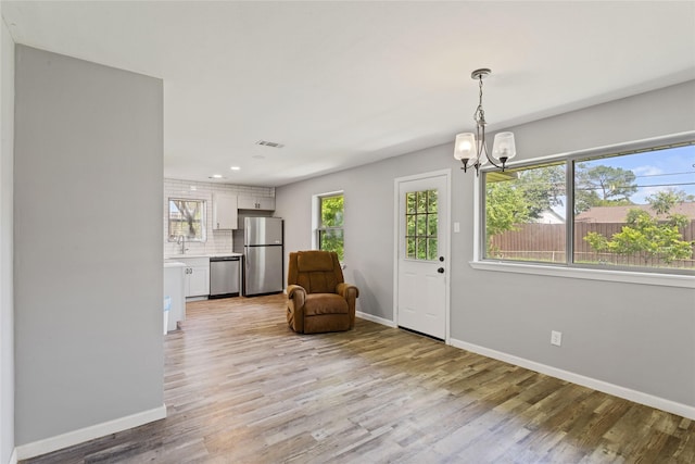 2628 Belhaven Dr, Mesquite, TX 75150 - living area with a chandelier, light wood finished floors, and recessed lighting