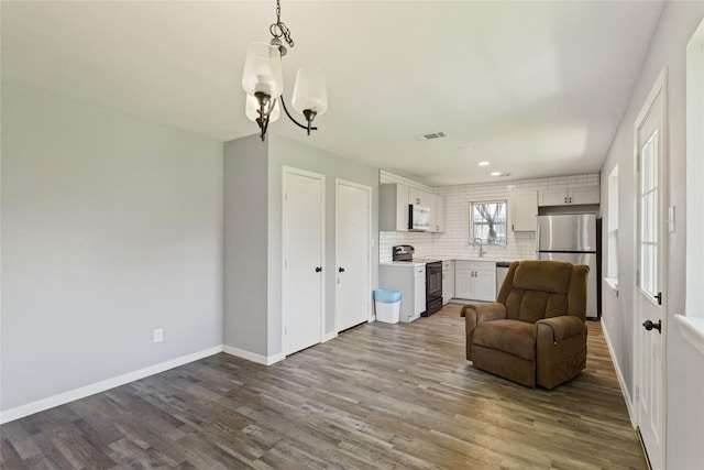 2628 Belhaven Dr, Mesquite, TX 75150 - living area with a chandelier, dark wood-style floors, and recessed lighting