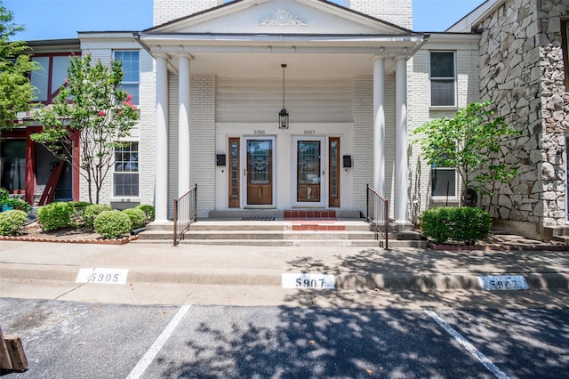 5907 Copperwood Ln Unit 1138, Dallas, TX 75248 - property entrance featuring uncovered parking, brick siding, a chimney, and a porch