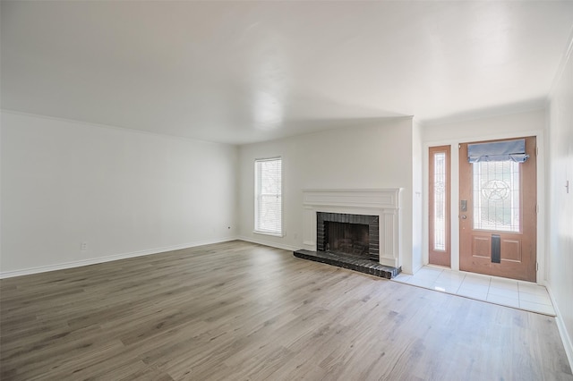 5907 Copperwood Ln Unit 1138, Dallas, TX 75248 - unfurnished living room with healthy amount of natural light, wood finished floors, and a brick fireplace