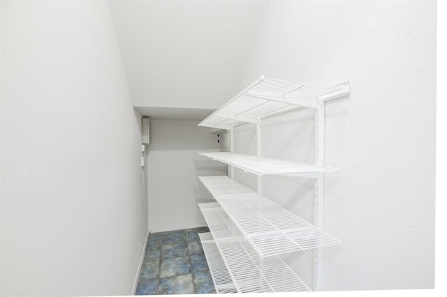 5907 Copperwood Ln Unit 1138, Dallas, TX 75248 - walk in closet featuring stone finish flooring