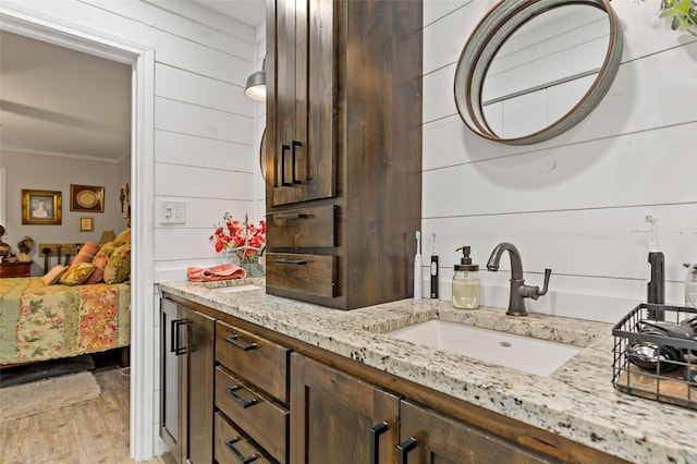 5270 Birch, Paris, TX 75462 - ensuite bathroom featuring crown molding, vanity, wood finished floors, and wood walls