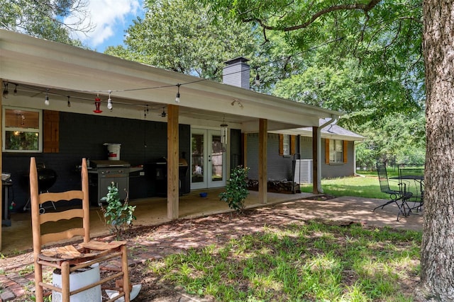 5270 Birch, Paris, TX 75462 - rear view of property featuring french doors, a chimney, and a patio area