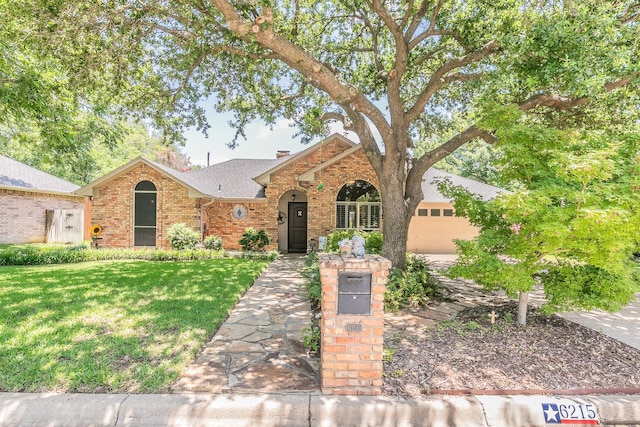 6215 Suffolk Dr, Arlington, TX 76001 - view of front of home with brick siding, an attached garage, a front yard, and roof with shingles