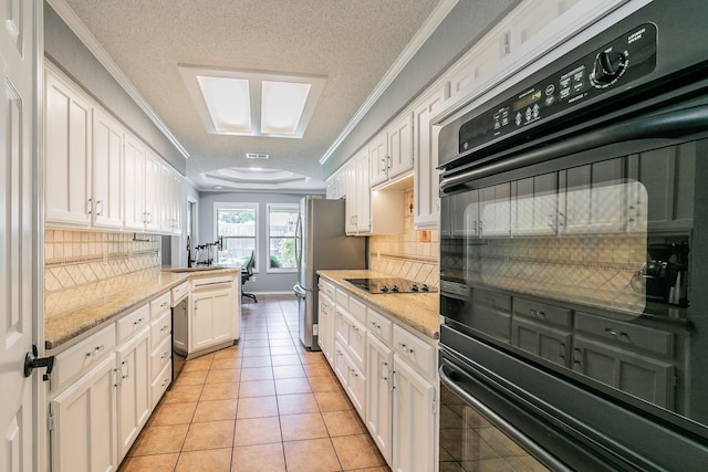6215 Suffolk Dr, Arlington, TX 76001 - kitchen featuring crown molding, white cabinetry, black appliances, backsplash, and light tile patterned floors