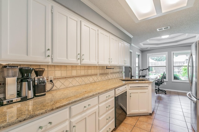 6215 Suffolk Dr, Arlington, TX 76001 - kitchen with black dishwasher, freestanding refrigerator, crown molding, tasteful backsplash, and white cabinetry