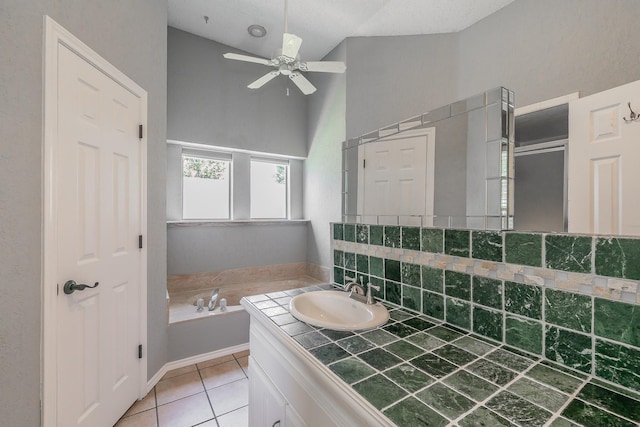 6215 Suffolk Dr, Arlington, TX 76001 - bathroom with vaulted ceiling, a ceiling fan, vanity, a bath, and tile patterned flooring