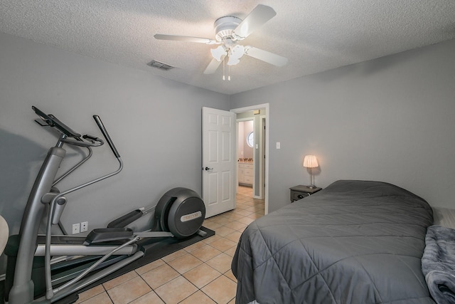 6215 Suffolk Dr, Arlington, TX 76001 - bedroom featuring a textured ceiling, light tile patterned floors, and a ceiling fan