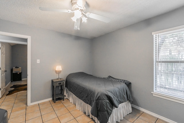 6215 Suffolk Dr, Arlington, TX 76001 - bedroom with light tile patterned flooring, a textured ceiling, and ceiling fan