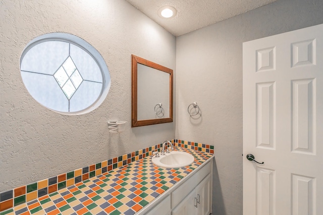 6215 Suffolk Dr, Arlington, TX 76001 - bathroom featuring vanity, a textured ceiling, and a textured wall