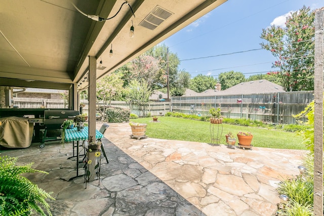 6215 Suffolk Dr, Arlington, TX 76001 - fenced backyard with a patio area