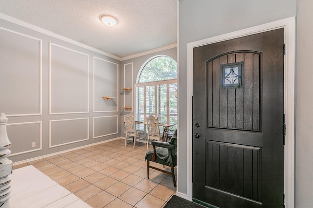 6215 Suffolk Dr, Arlington, TX 76001 - foyer entrance featuring a decorative wall, ornamental molding, light tile patterned floors, and a textured ceiling