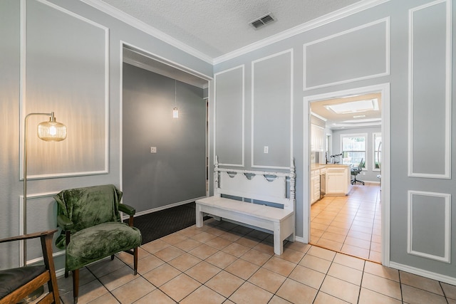 6215 Suffolk Dr, Arlington, TX 76001 - interior space featuring ornamental molding, light tile patterned floors, a decorative wall, and a textured ceiling