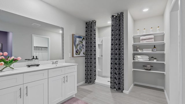 9453 Mint Hill Dr, Fort Worth, TX 76108 - bathroom featuring wood finished floors, vanity, a stall shower, and recessed lighting