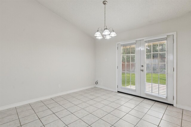 2017 Jessie Pl, Edgecliff Village, TX 76134 - unfurnished dining area featuring french doors, a chandelier, a textured ceiling, light tile patterned floors, and lofted ceiling
