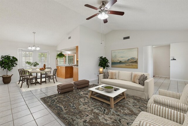 2017 Jessie Pl, Edgecliff Village, TX 76134 - living area with vaulted ceiling, light tile patterned flooring, a chandelier, ceiling fan, and a textured ceiling