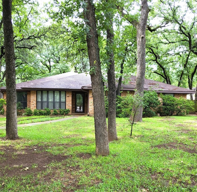 697 Highland Crest Dr, Hurst, TX 76054 - view of front of home featuring brick siding and a front lawn