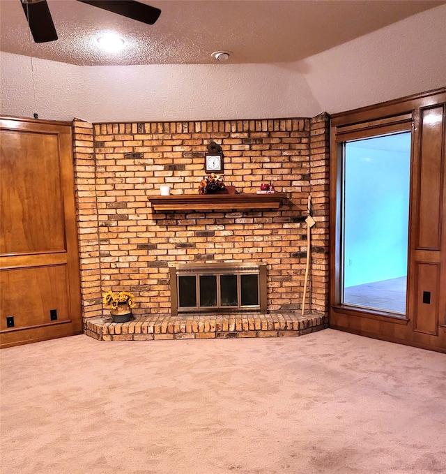697 Highland Crest Dr, Hurst, TX 76054 - unfurnished living room featuring a ceiling fan, carpet floors, lofted ceiling, a textured ceiling, and a fireplace