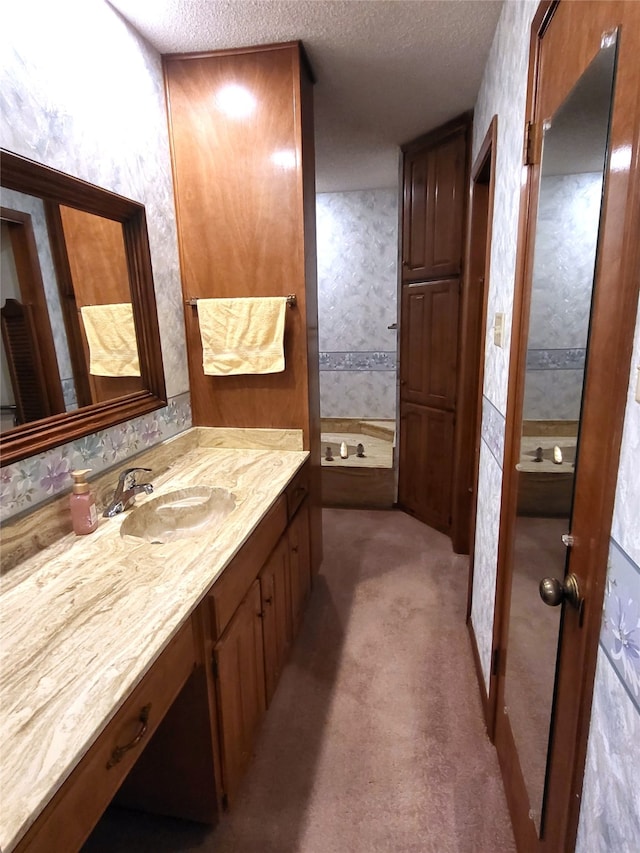 697 Highland Crest Dr, Hurst, TX 76054 - bathroom featuring a textured ceiling, vanity, and a tub to relax in